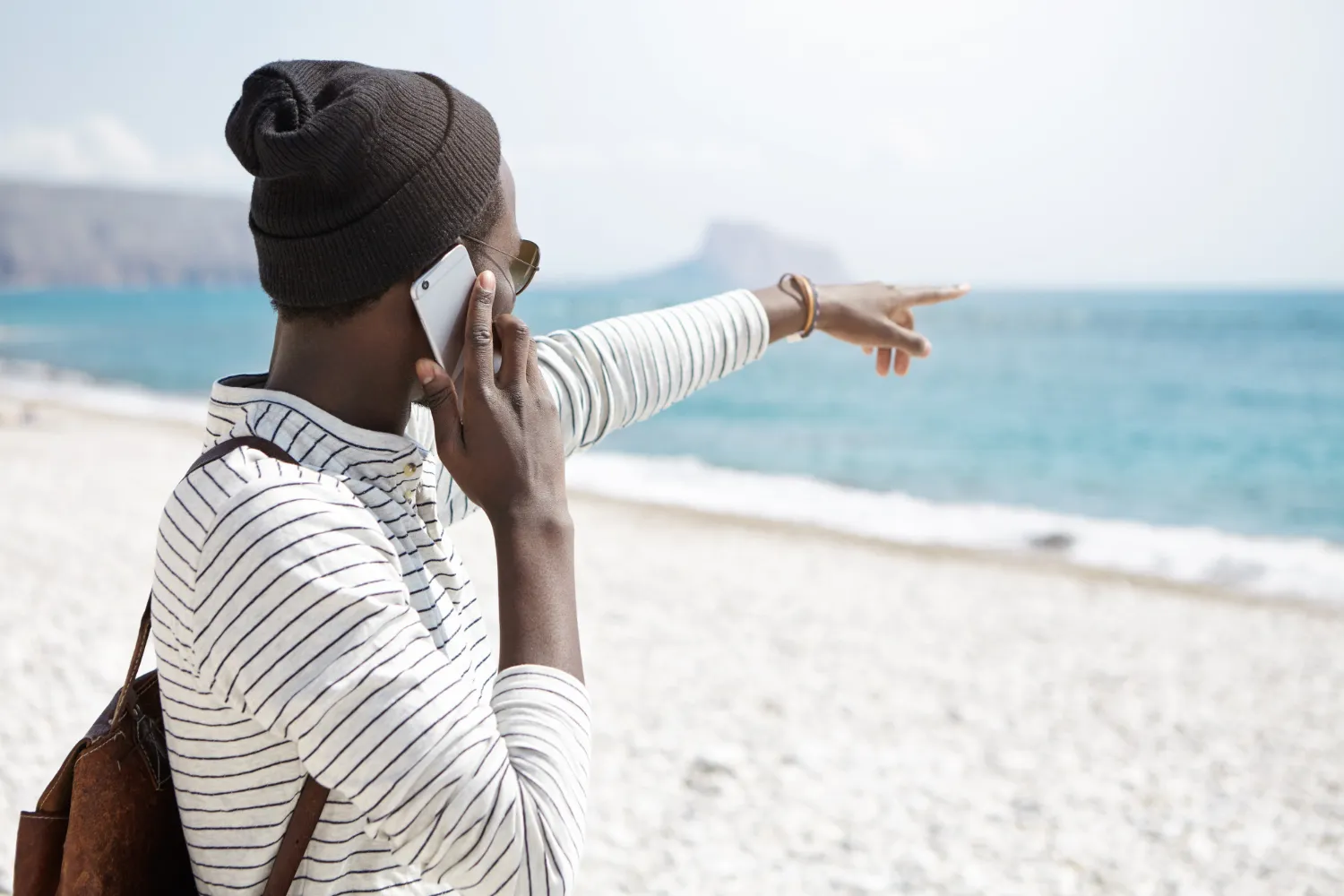 Traveller pointing towards the horizon in Malawi, enjoying the open landscape